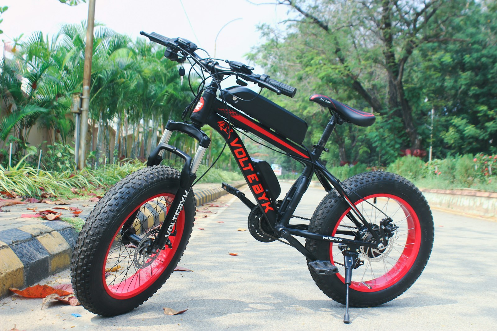a black and red bike parked on the side of a road